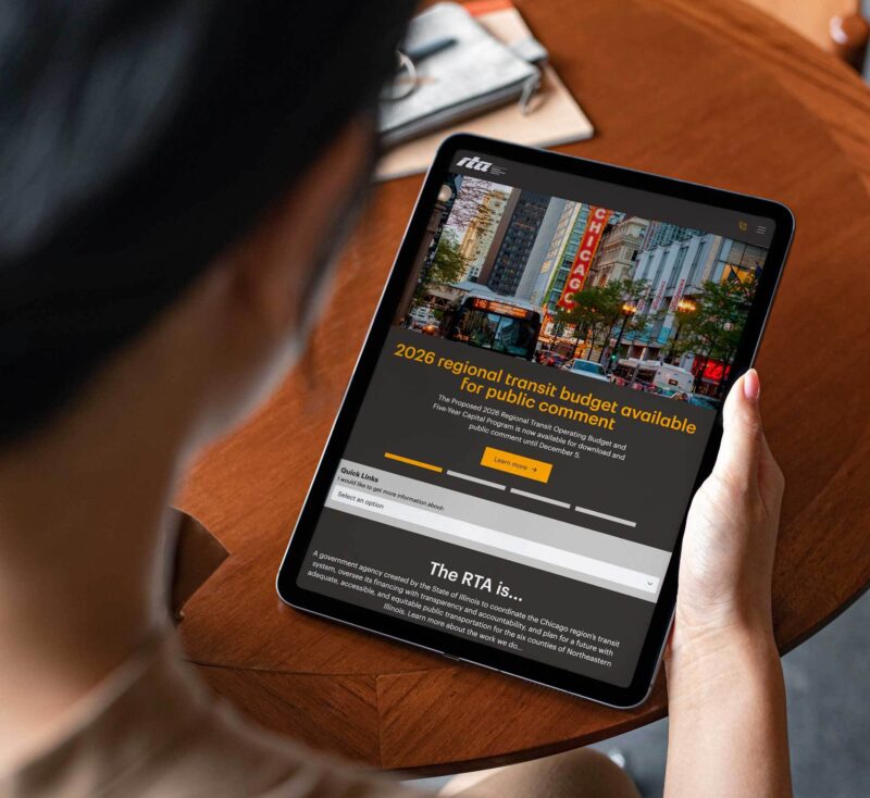 Person holding iPad browsing transit website